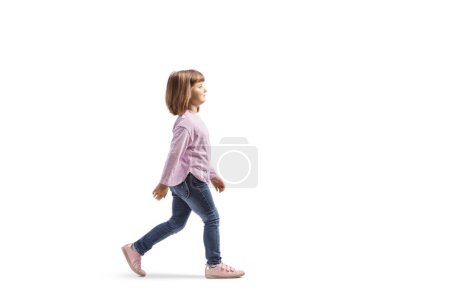 Téléchargez les photos : Full length profile shot of a five year old girl walking isolated on white background - en image libre de droit