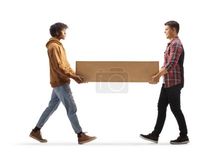 Photo for Caucasian and african american guy carrying a cardboard box together isolated on white background - Royalty Free Image
