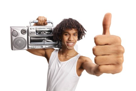 Photo for African american young man holding a boombox shoulder and showing thumbs up isolated on white background - Royalty Free Image