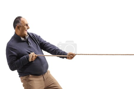 Téléchargez les photos : Profile shot of a mature man pulling a rope isolated on white background - en image libre de droit