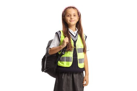 Photo for Schoolgirl with a backpack wearing a reflective safety vest isolated on white background - Royalty Free Image