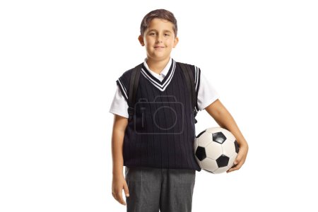 Foto de Schoolboy wearing a school uniform and holding a football isolated on white background - Imagen libre de derechos