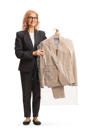 Foto de Woman collecting suit from dry cleaners isolated on a white background - Imagen libre de derechos
