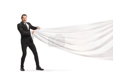 Foto de Businessman pulling a white piece of cloth isolated on white background - Imagen libre de derechos