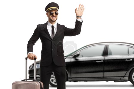 Téléchargez les photos : Chauffeur with a suitcase in front of a black car waving isolated on white background - en image libre de droit