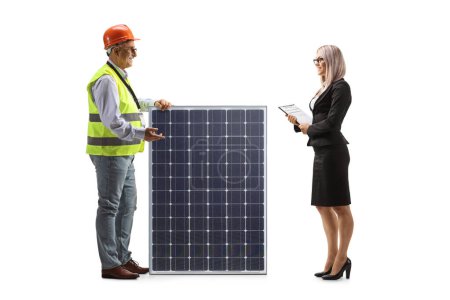 Photo for Mature male engineer explaining about a solar panel to a female businesswoman isolated on white background - Royalty Free Image