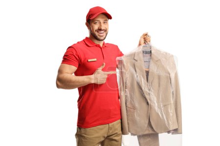 Téléchargez les photos : Dry cleaning worker holding a suit on a hanger with a plastic cover isolated on a white backgroun - en image libre de droit