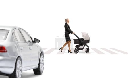 Photo for Full length profile shot of a businesswoman pushing a pushchair on a pedestrian crossing isolated on white background - Royalty Free Image