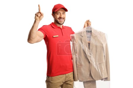 Photo for Worker holding a suit on a hanger with a plastic cover and pointing up isolated on a white backgroun - Royalty Free Image