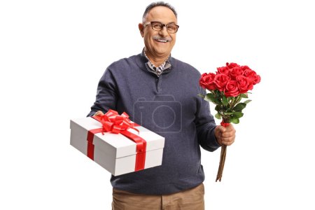 Photo for Mature man holding a gift box and red roses isolated on white background - Royalty Free Image