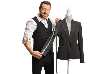 Photo for Tailor measuring a sleeve from a suit on a mannequin torso isolated on white background - Royalty Free Image