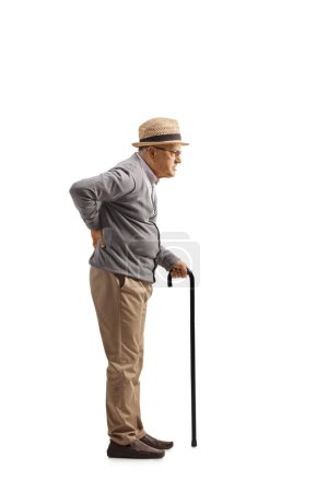 Photo for Full length profile shot of an elderly man holding his painful back isolated on white background - Royalty Free Image