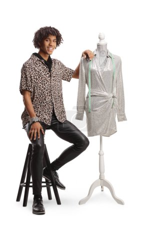 Photo for African american male fashion designer with a dress on a doll mannequin isolated on white background - Royalty Free Image