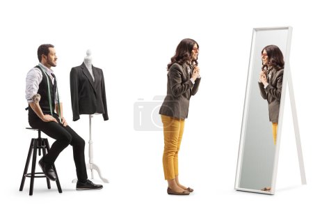 Photo for Young woman trying on a garment at the tailors shop isolated on white background - Royalty Free Image