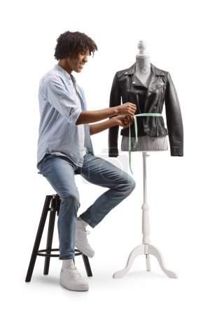Photo for African american fashion designer measuring a jacket on a mannequin isolated on white background - Royalty Free Image