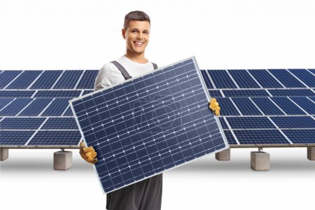 Photo for Technician holding a solar panel and smiling at a solar farm isolated on white background - Royalty Free Image