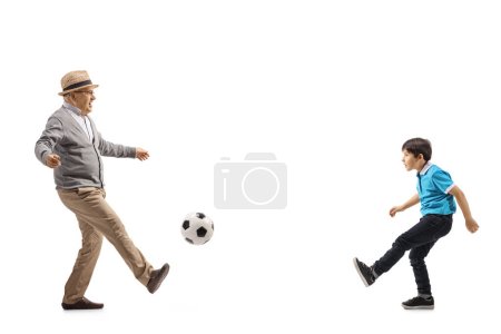 Photo for Grandfather and grandson kicking football isolated on white background - Royalty Free Image