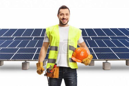Photo for Construction worker holding a helmet in front of a photovoltaic farm isolated on white background - Royalty Free Image