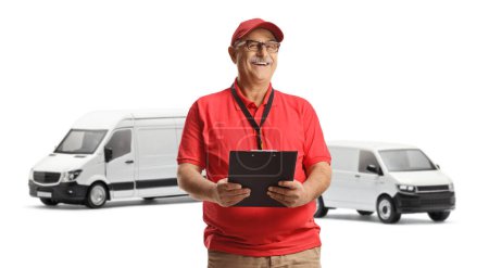 Photo for Mature male courier posing in front of white vans isolated on white background - Royalty Free Image