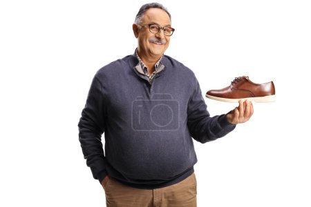 Photo for Cheerful mature man holding a brown leather shoe isolated on white background - Royalty Free Image
