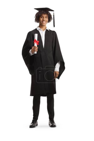 Photo for Full length portrait of a male african american student wearing a graduation gown and holding a diploma isolated on white background - Royalty Free Image