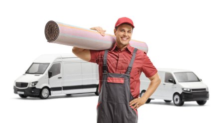 Photo for Male worker carrying a carpet in front of two ehite vans isolated on white background - Royalty Free Image
