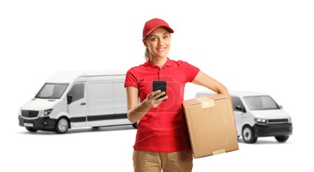 Photo for Delivery woman with vans holding a cardboard box using a mobile phone isolated on white background - Royalty Free Image