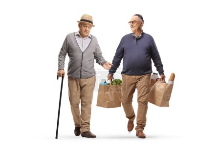 Photo for Mature man walking, carrying grocery bags and having a conversation with a pensioner isolated on white background - Royalty Free Image