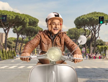 Photo for Cheerful mature man riding a scooter in Rome, Italy - Royalty Free Image