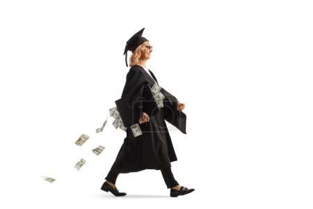 Foto de Foto de perfil de longitud completa de una mujer en un vestido de graduado caminando y llevando un caso con dinero aislado sobre fondo blanco - Imagen libre de derechos
