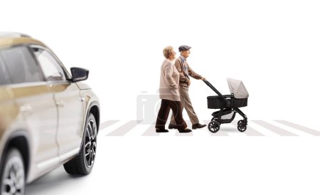 Photo for Full length profile shot of elderly man and woman crossing a street at a pedestrian with a pushchair isolated on white background - Royalty Free Image