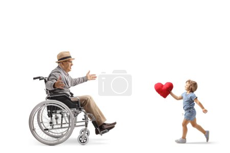 Photo for Little girl carrying a red heart and running to hug an elderly man in a wheelchair isolated on white background - Royalty Free Image