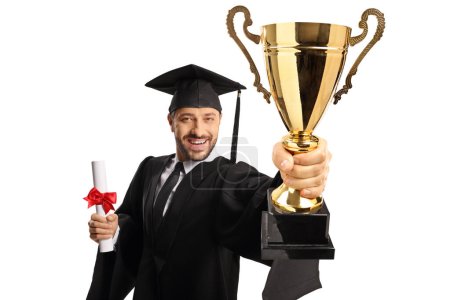 Photo for Full length portrait of a happy young man wearing a graduation gown and holding a gold trophy cup isolated on white background - Royalty Free Image