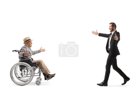 Photo for Businessman meeting an elderly man in a wheelchair isolated on white backgroun - Royalty Free Image