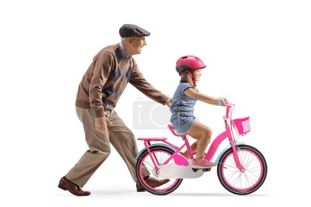 Photo for Grandfather teaching a little girl how to ride a bicycle isolated on white background - Royalty Free Image