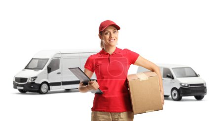 Photo for Female delivery worker holding a clipboard and a box in front of transport vans isolated on white background - Royalty Free Image
