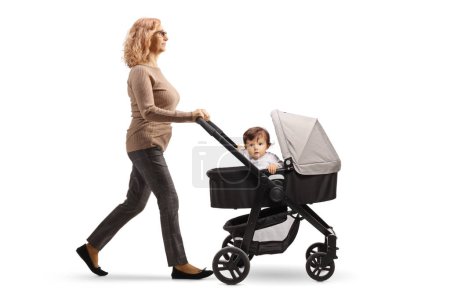 Photo for Full length profile shot of a mature woman pushing a baby in a stroller isolated on white backgroun - Royalty Free Image