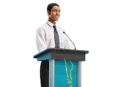 Photo for Young african american man standing behind a podium and smiling isolated on white background - Royalty Free Image