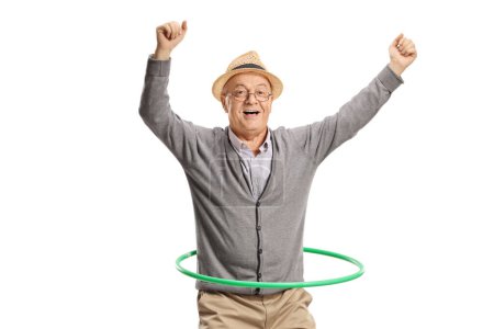 Photo for Portrait of an excited elderly man spinning a hula hoop isolated on white background - Royalty Free Image