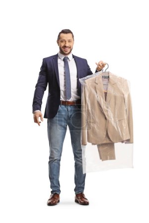 Photo for Man collecting a suit from dry cleaners isolated on a white backgroun - Royalty Free Image