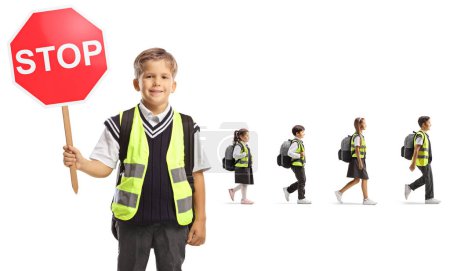 Photo for Schoolboy with a reflective vest holding a stop sign and children walking behind isolated on white background - Royalty Free Image