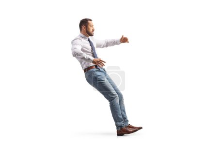Photo for Full length profile shot of a man falling isolated on white background - Royalty Free Image