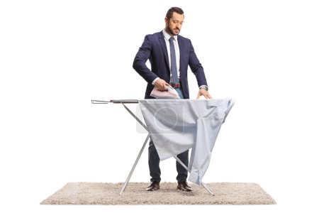 Photo for Businessman ironing a shirt isolated on white background - Royalty Free Image