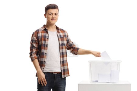 Young man putting a vote in an election box and looking at the camera isolated on white background