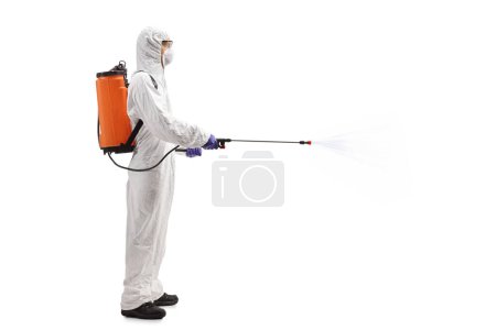 Photo for Full length profile shot of a professional in a hazmat suit spraying a disinfectant isolated on white background - Royalty Free Image