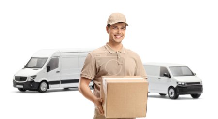 Photo for Delivery guy holding a package and standing in front of transport vans isolated on white background - Royalty Free Image