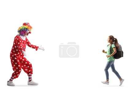 Photo for Girl with a backpack running towards a clown isolated on white backgroun - Royalty Free Image