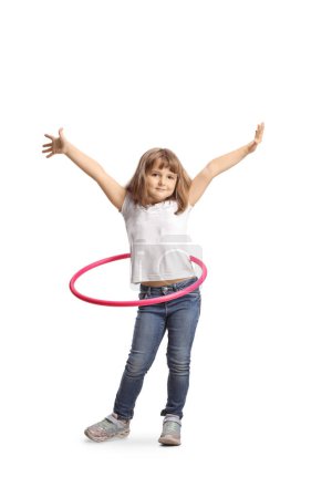 Photo for Full length portrait of a little girl spinning a hula hoop and smiling isolated on white background - Royalty Free Image