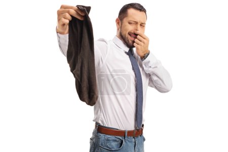 Foto de Empresario sosteniendo un par de calcetines malolientes aislados sobre fondo blanco - Imagen libre de derechos