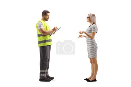 Photo for Young woman talking to a road assistance agent in a reflective vest isolated on white background - Royalty Free Image